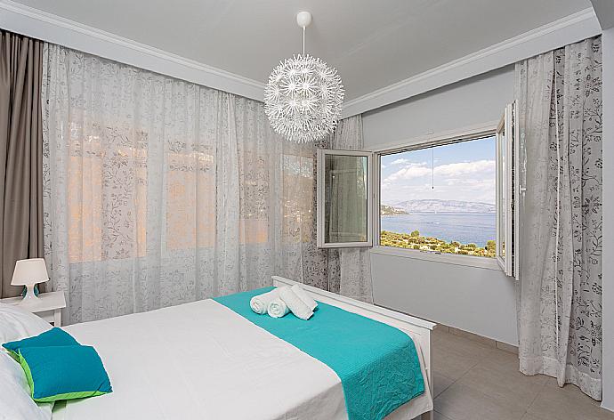 Double bedroom with en suite bathroom, A/C, living area, walk-in wardrobe, and balcony access . - Villa Aurora . (Photo Gallery) }}