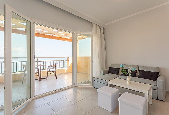 Double bedroom with en suite bathroom, A/C, living area, walk-in wardrobe, and balcony access . - Villa Aurora . (Photo Gallery) }}