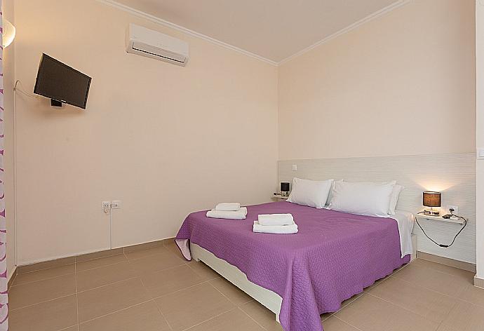 Double bedroom on second floor with en suite bathroom, A/C, TV, and balcony access . - Villa Alya . (Photo Gallery) }}