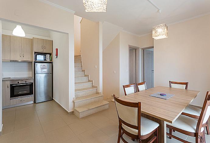 Dining area and kitchen on first floor with A/C and balcony access . - Villa Alya . (Galerie de photos) }}