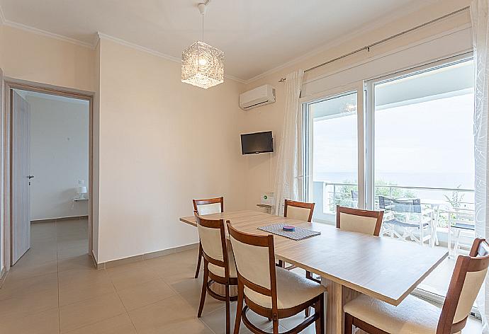Dining area and kitchen on first floor with A/C and balcony access . - Villa Alya . (Galería de imágenes) }}
