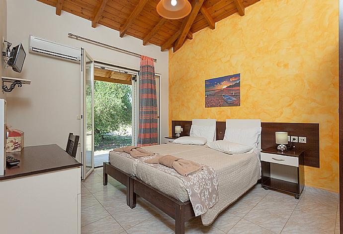 Twin bedroom with A/C and TV . - Villa Popi . (Photo Gallery) }}