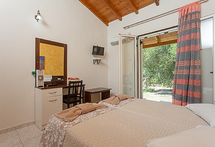 Twin bedroom with A/C and TV . - Villa Popi . (Photo Gallery) }}