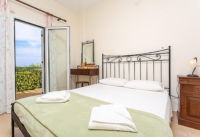 Double bedroom on ground floor with en suite bathroom, A/C, and balcony access . - Skala Villa Green . (Photo Gallery) }}