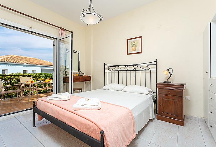 Double bedroom on ground floor with en suite bathroom, A/C, and terrace access . - Skala Villa Yellow . (Photo Gallery) }}