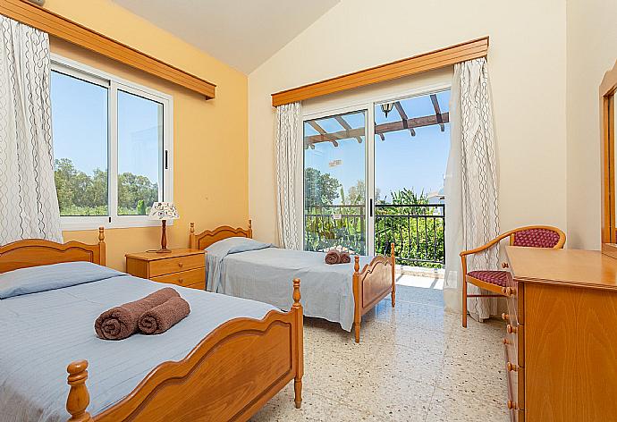 Twin bedroom with en suite bathroom, A/C, and balcony access with sea views . - Sun Beach Villa Thio . (Photo Gallery) }}