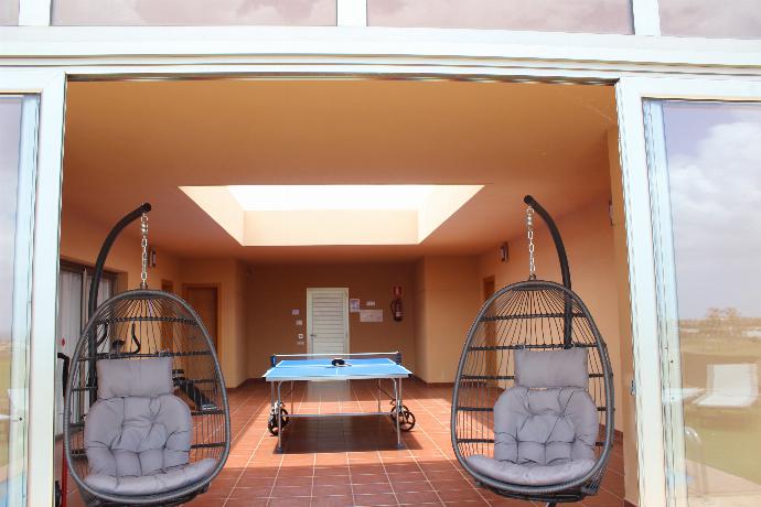 Ping pong table, gym area and swing chairs . - Villa Domingo . (Photo Gallery) }}