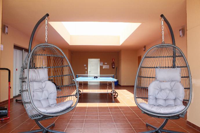 Ping pong table, gym area and swing chairs . - Villa Domingo . (Photo Gallery) }}