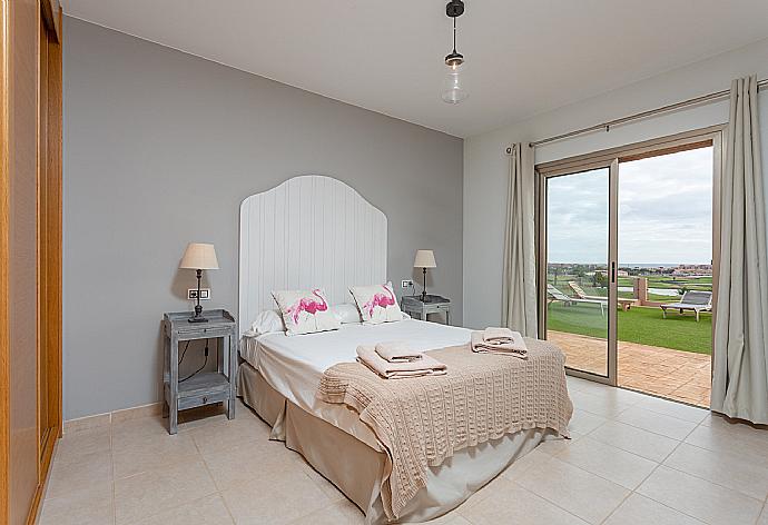 Double bedroom with en suite bathroom and pool terrace access . - Villa Barquetta . (Photo Gallery) }}