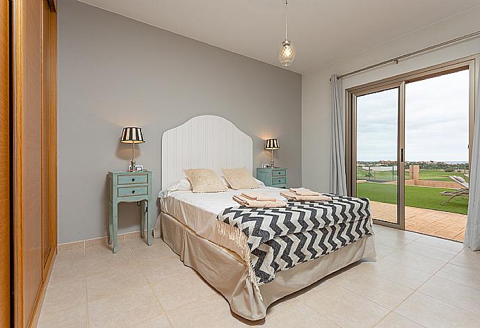 Double bedroom with en suite bathroom and pool terrace access . - Villa Tahiche . (Photo Gallery) }}