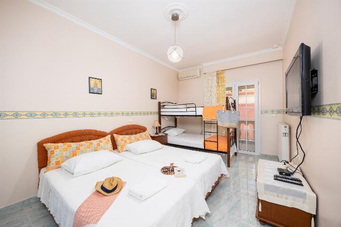 Bedroom with twin beds, bunkbed, and A/C . - Villa Psaropouli . (Photo Gallery) }}