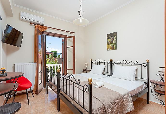 Twin bedroom with A/C, satellite TV, and terrace access . - Villa Mansion . (Photo Gallery) }}