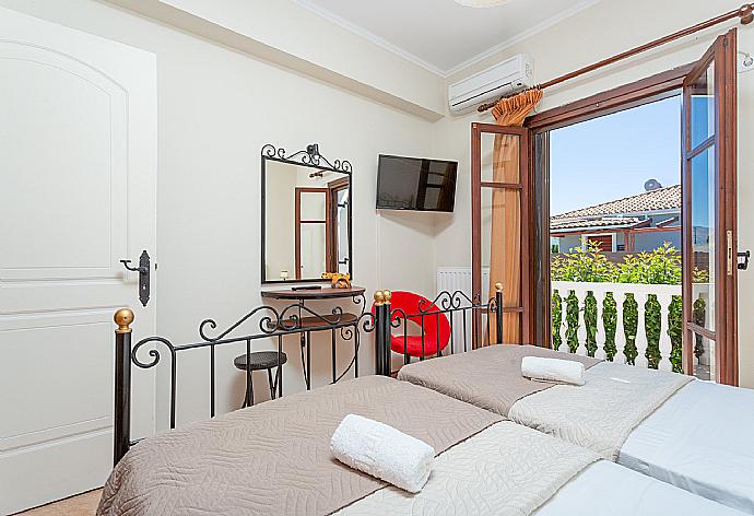 Twin bedroom with A/C, satellite TV, and terrace access . - Villa Mansion . (Галерея фотографий) }}