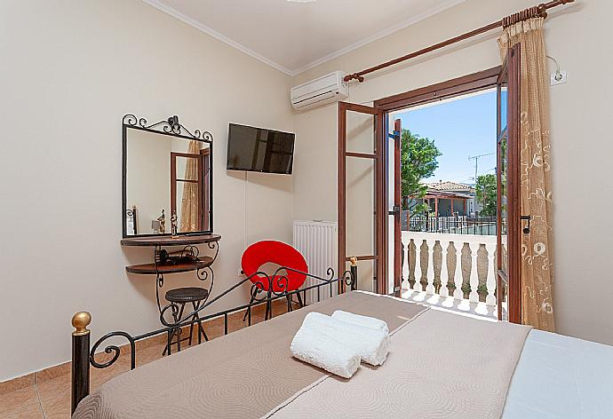 Double bedroom with A/C, TV, and terrace access . - Villa Rose . (Photo Gallery) }}