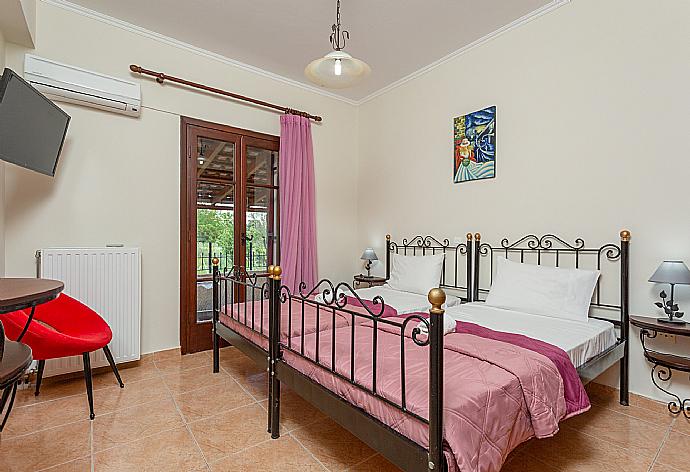 Twin bedroom with A/C, TV, and terrace access . - Villa Bora . (Photo Gallery) }}