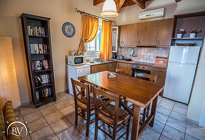 Equipped kitchen with dining area  . - Villa Akrogiali . (Photo Gallery) }}