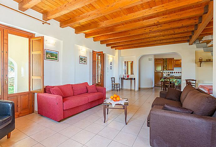 Open-plan living room with sofas, dining area, kitchen, WiFi internet, satellite TV, and terrace access . - Villa Annunziata . (Galleria fotografica) }}