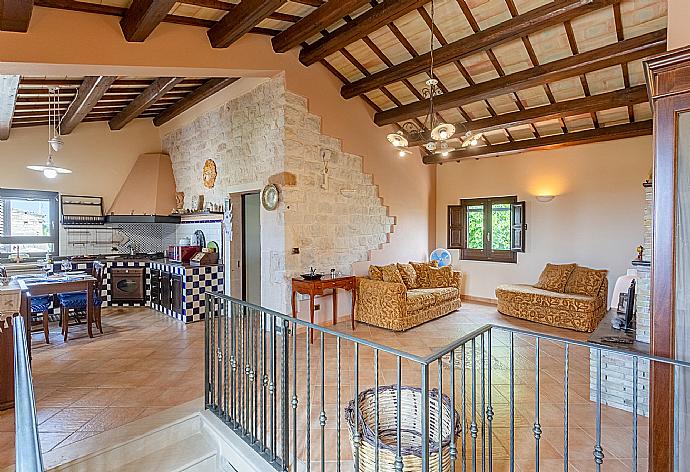 Open-plan living room on first floor of main building with sofas, dining area, kitchen, ornamental fireplace, WiFi internet, satellite TV, and balcony access . - Villa Aziz . (Galleria fotografica) }}