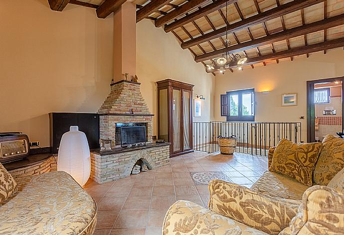 Open-plan living room on first floor of main building with sofas, dining area, kitchen, ornamental fireplace, WiFi internet, satellite TV, and balcony access . - Villa Aziz . (Fotogalerie) }}