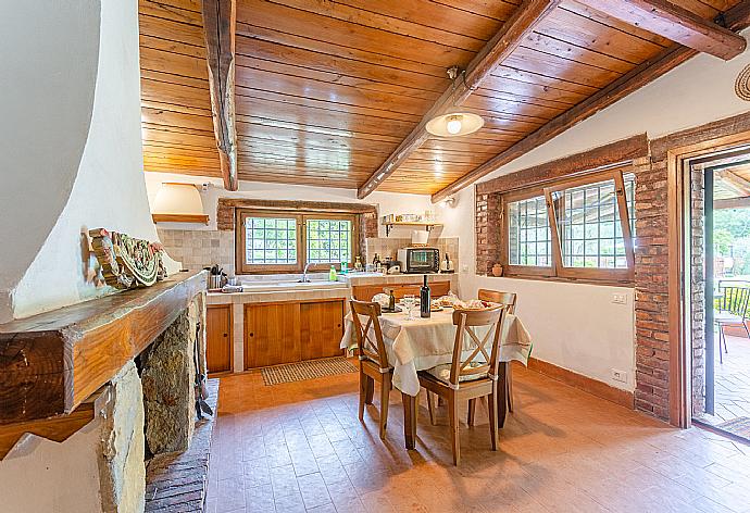 Open-plan living room with dining area, kitchen, ornamental fireplace, and terrace access . - Villa Casale Terra Farfa . (Photo Gallery) }}