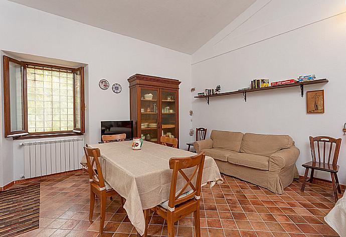 Open-plan room with double bed, dining area, sofa bed, kitchenette, and ornamental fireplace . - Villa Casale Terra Farfa . (Photo Gallery) }}