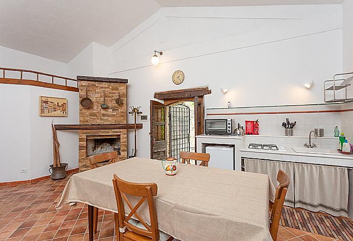 Open-plan room with double bed, dining area, sofa bed, kitchenette, and ornamental fireplace . - Villa Casale Terra Farfa . (Photo Gallery) }}