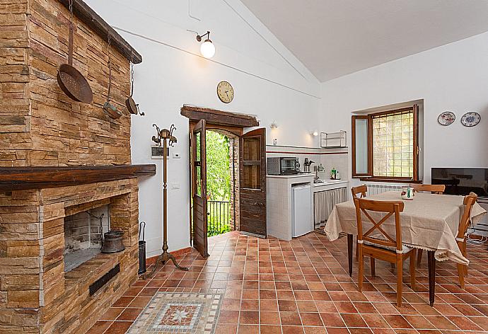Open-plan room with double bed, dining area, sofa bed, kitchenette, and ornamental fireplace . - Villa Casale Terra Farfa . (Photo Gallery) }}