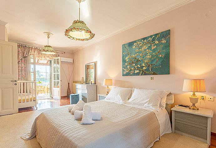 Double bedroom with en suite bathroom, A/C, and dual balcony access . - Villa Durrell . (Photo Gallery) }}