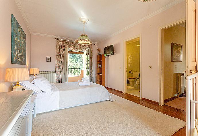 Double bedroom with en suite bathroom, A/C, and dual balcony access . - Villa Durrell . (Photo Gallery) }}