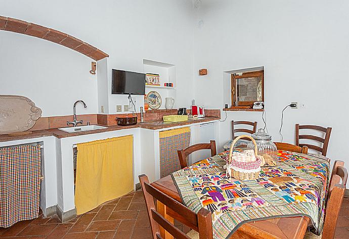 Dining room with kitchenette on first floor of main building . - Villa Casale Silvia . (Галерея фотографий) }}