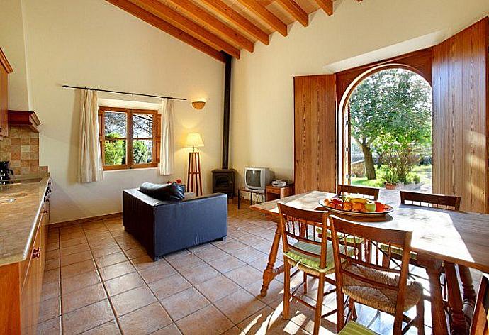 Open-plan living room with sofa, dining area, kitchen, A/C, WiFi internet, satellite TV, and terrace access  . - Villa Son Amer . (Галерея фотографий) }}