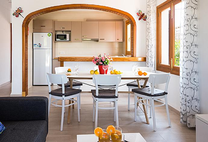 Open-plan living room with sofas, dining area, kitchen,  WiFi internet, and satellite TV . - Villa Cubells . (Galleria fotografica) }}