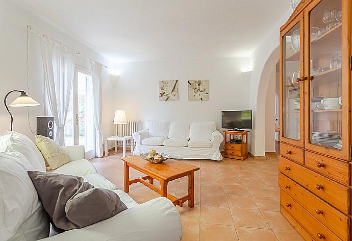 Open-plan living room with sofas, dining area, kitchen, ornamental fireplace, WiFi internet, satellite TV, DVD player, and terrace access . - Villa Corb Mari . (Galleria fotografica) }}