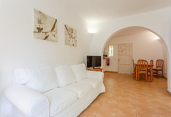 Open-plan living room with sofas, dining area, kitchen, ornamental fireplace, WiFi internet, satellite TV, DVD player, and terrace access . - Villa Corb Mari . (Galleria fotografica) }}