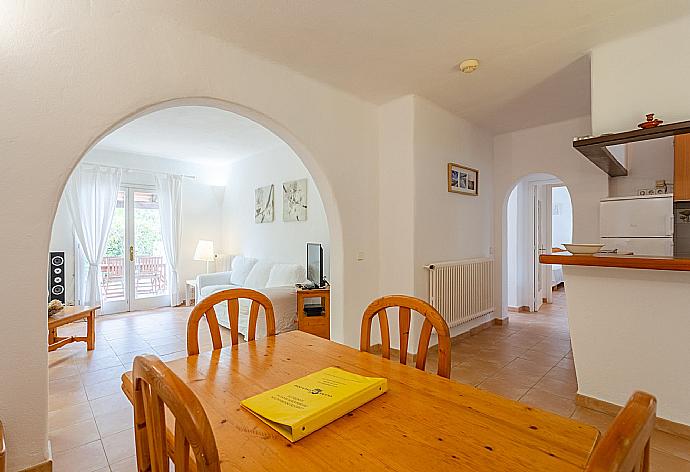 Open-plan living room with sofas, dining area, kitchen, ornamental fireplace, WiFi internet, satellite TV, DVD player, and terrace access . - Villa Corb Mari . (Galerie de photos) }}