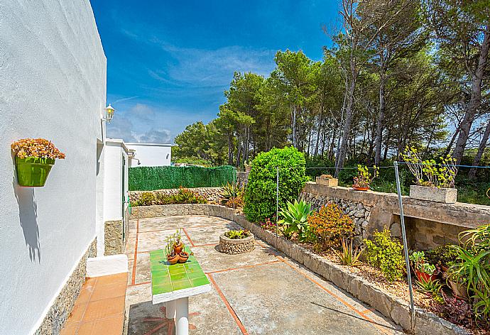 Rear terrace and garden area . - Villa Can Joan . (Photo Gallery) }}