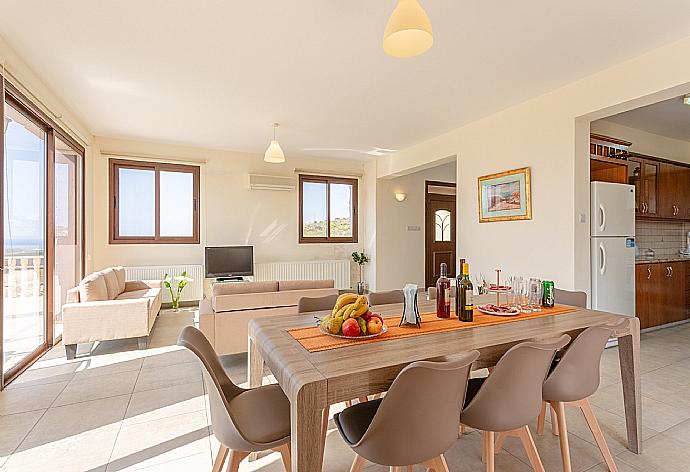 Open-plan living room with sofas, dining area, kitchen, ornamental fireplace, A/C, WiFi internet, satellite TV, DVD player, and pool terrace access . - Villa Rallo . (Galleria fotografica) }}