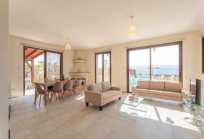 Open-plan living room with sofas, dining area, kitchen, ornamental fireplace, A/C, WiFi internet, satellite TV, DVD player, and pool terrace access . - Villa Rallo . (Fotogalerie) }}