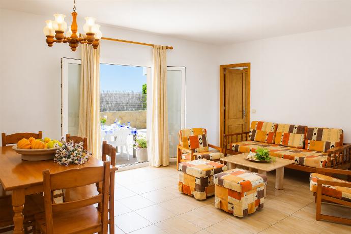 Living room with sofas, and dining area . - Villa Roca Nova . (Photo Gallery) }}