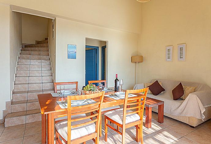 Open-plan living room with sofa, dining area, kitchen, A/C, WiFi internet, satellite TV, and pool terrace access . - Villa Thalassaki . (Галерея фотографий) }}