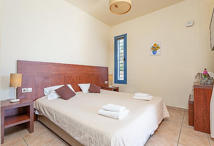 Double bedroom with A/C, TV, and terrace access . - Villa Thalassaki . (Photo Gallery) }}