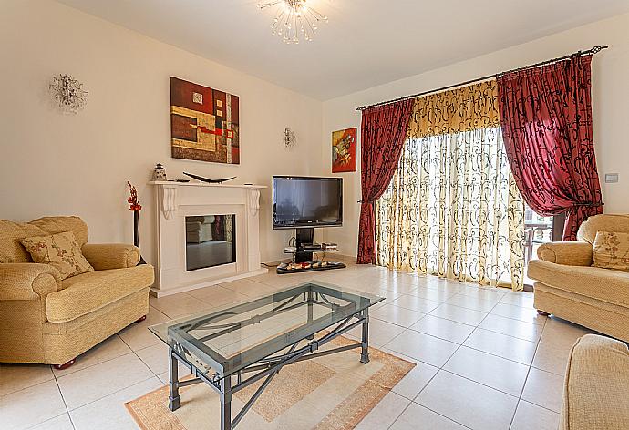 Living room with sofas, ornamental fireplace, A/C, WiFi internet, satellite TV, DVD player, and pool terrace and balcony access . - Villa Evelina . (Photo Gallery) }}