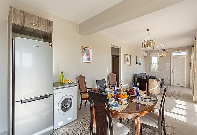 Open-plan living room with sofas, dining area, kitchen, A/C, WiFi internet, satellite TV, and terrace access . - Vatsa Beach Villa . (Galerie de photos) }}