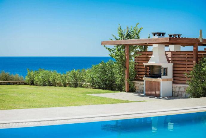 Outdoor area with BBQ . - Villa Tsampikos . (Photo Gallery) }}