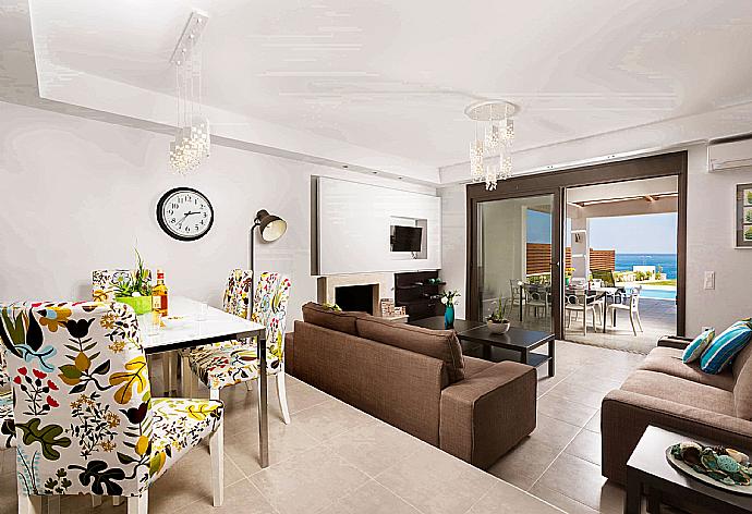 Open plan living room with WiFi Internet, Satellite TV, DVD player, dining area and ornamental fire place. . - Villa Dionysos . (Галерея фотографий) }}