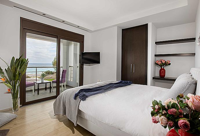 Double bedroom with terrace access and TV . - Villa Dionysos . (Галерея фотографий) }}