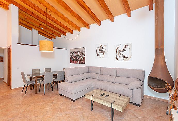 Living room with sofas, dining area, ornamental fireplace, WiFi internet, satellite TV, DVD player, and terrace access . - Villa Casa Xaloc . (Galería de imágenes) }}