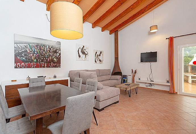 Living room with sofas, dining area, ornamental fireplace, WiFi internet, satellite TV, DVD player, and terrace access . - Villa Casa Xaloc . (Galería de imágenes) }}