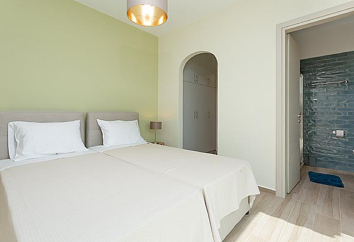 Twin bedroom with en suite bathroom, A/C, and balcony access with sea views . - Villa Lassi Illios . (Photo Gallery) }}