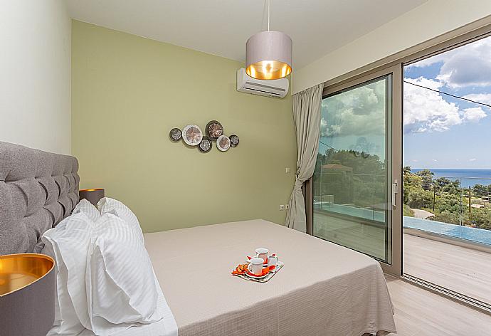 Double bedroom with en suite bathroom, A/C, and terrace access with sea views . - Villa Lassi Illios . (Photo Gallery) }}